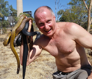 Snake Expert Ray Hoser with a handful of deadly snakes at a Snake Handling course clients facility